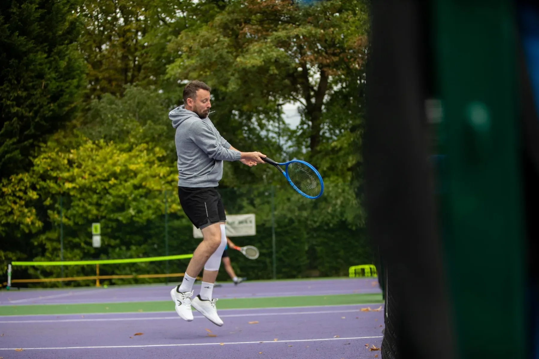 An adult player hitting a volley