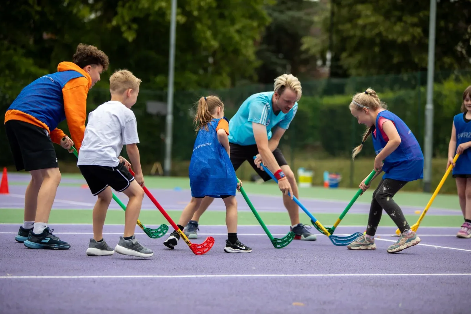 Children playing hockey at holiday camp