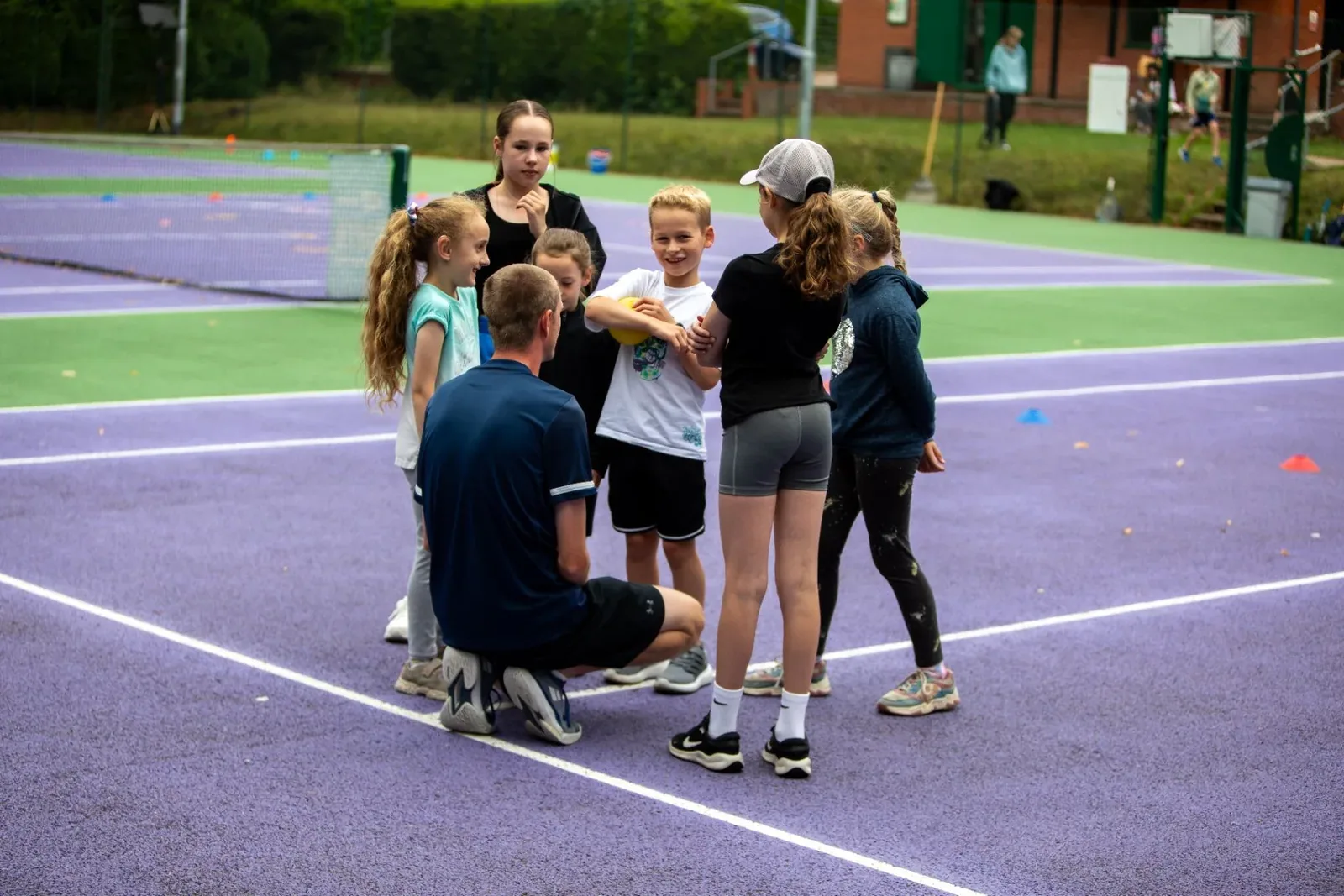 A holiday camp group huddled around a coach