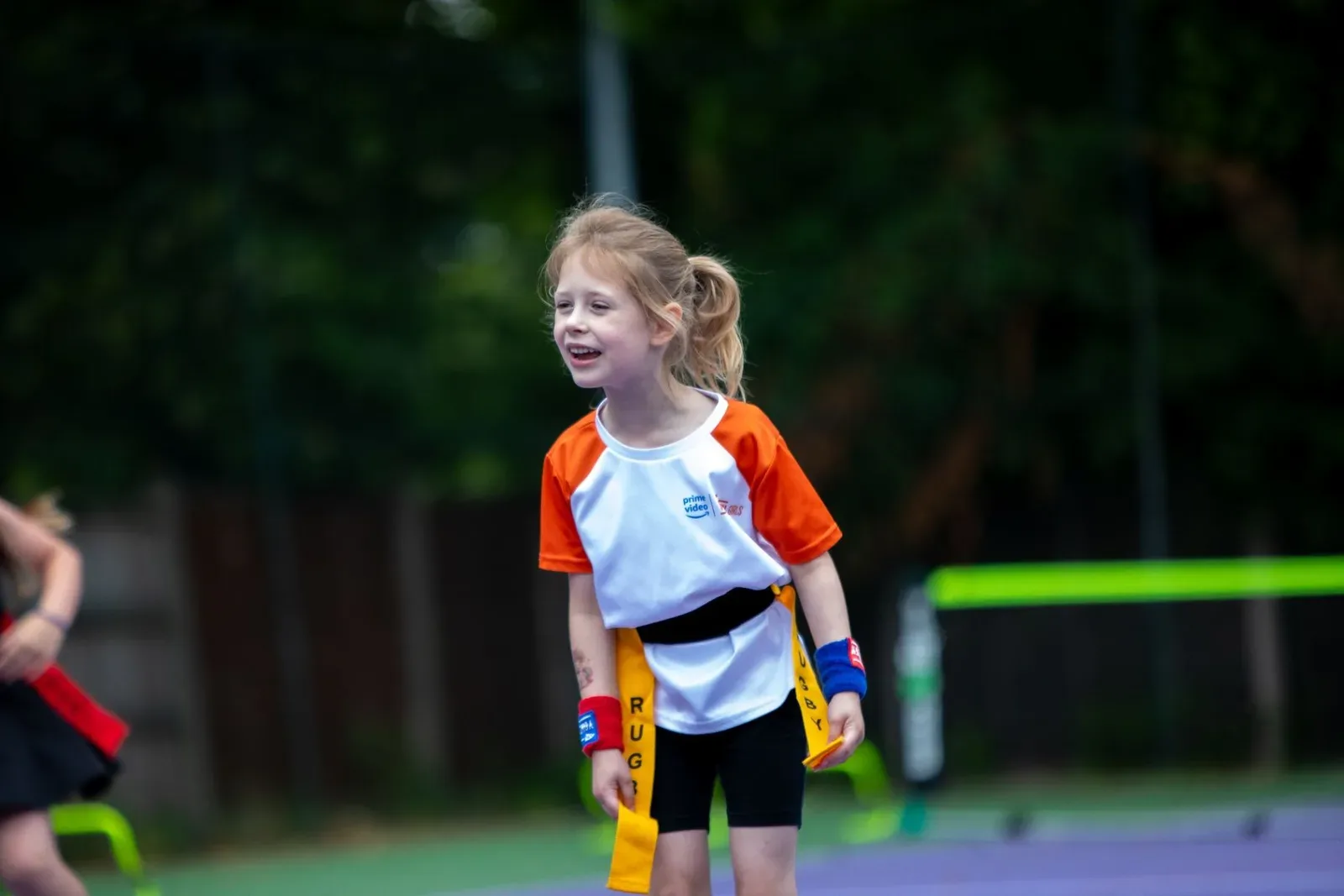 A young player smiling during a junior coaching session