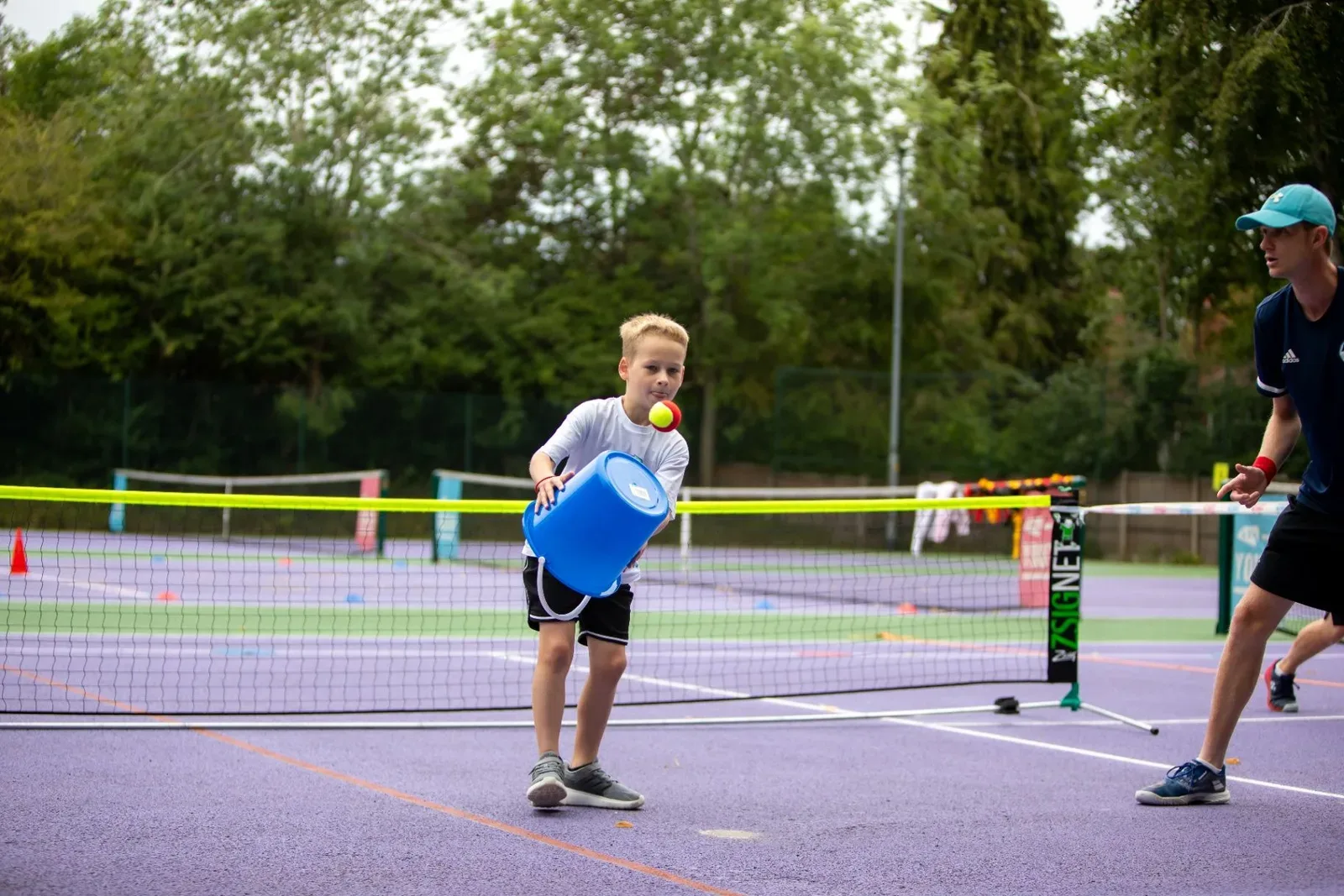A young player running to the net with a ball