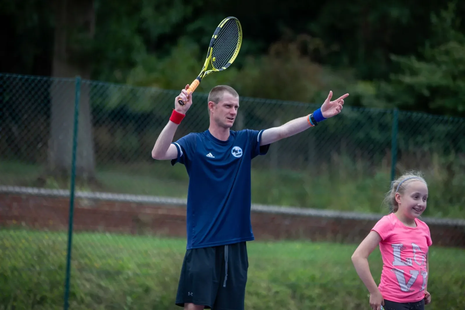 A coach celebrating on court with a young player